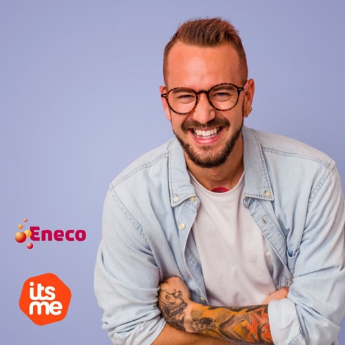 A man with glasses, with his arms crossed is smiling and looking straight into the camera